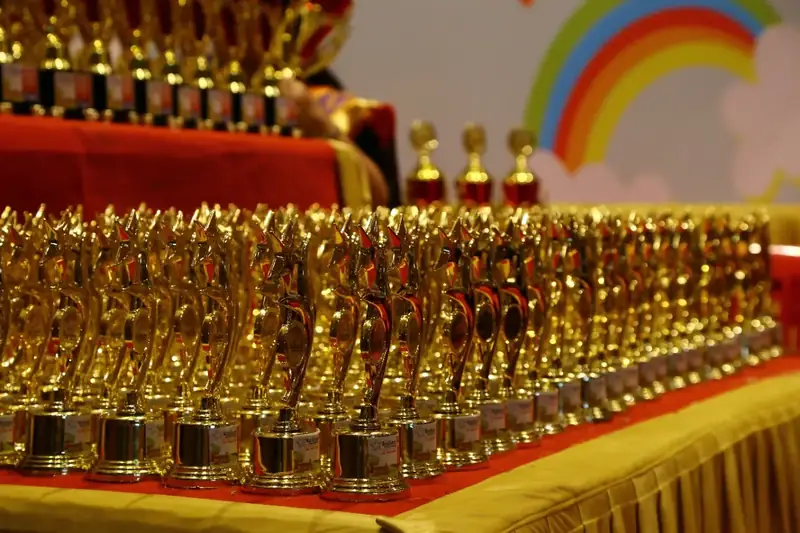 Rows of golden trophies arranged before the prize ceremony