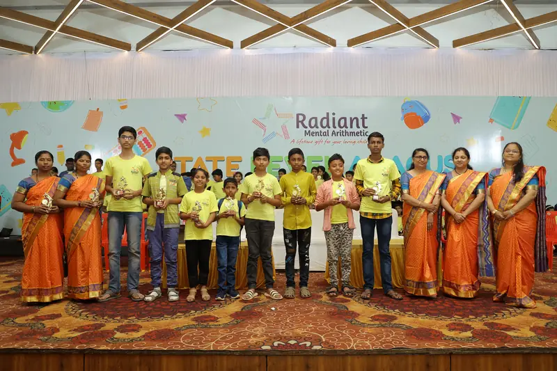 Students receiving awards on stage alongside their mentors